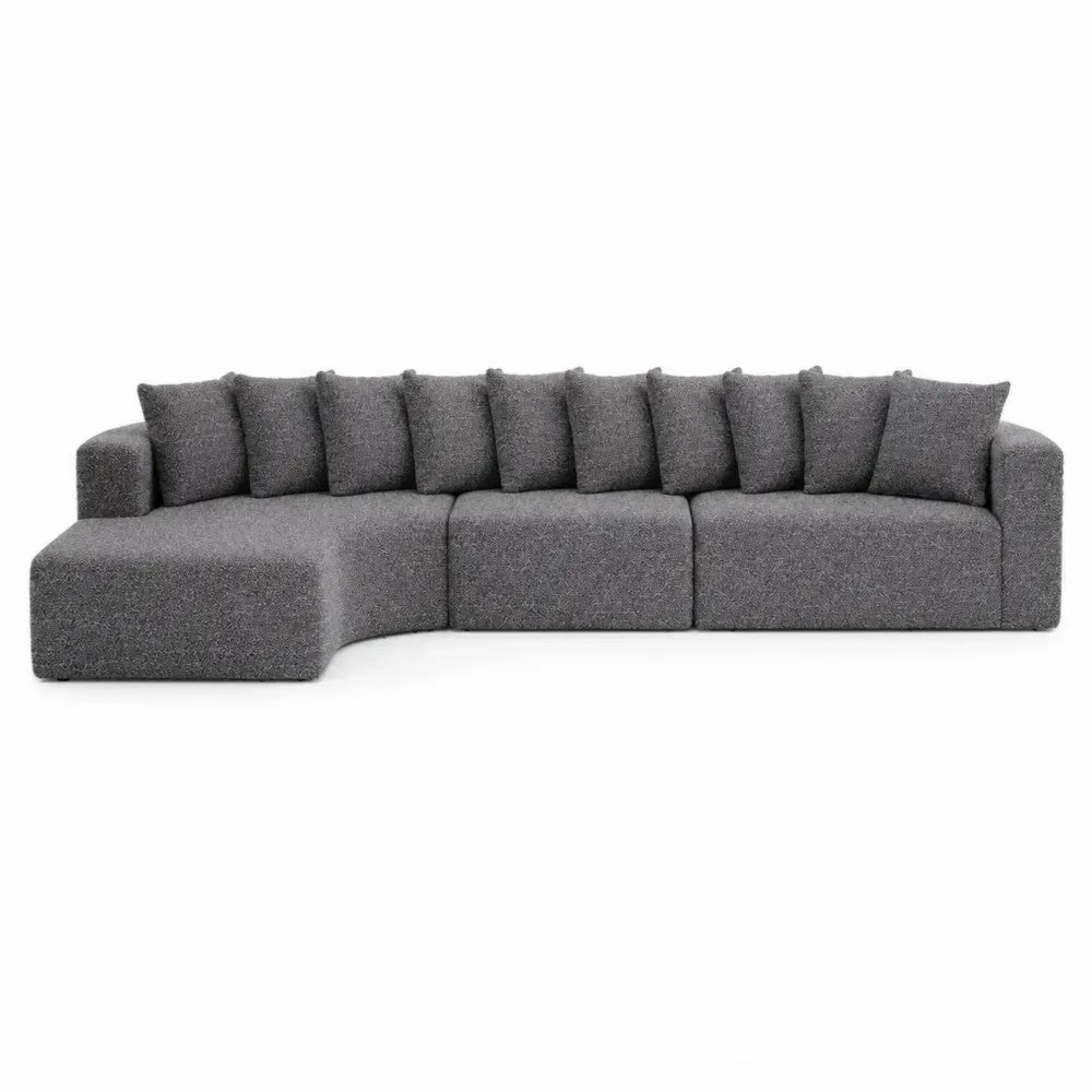 Sofá modular en L tapizado en tejido de poliéster gris con chaise longue lateral y cojines 300 x 160 x 85 cm